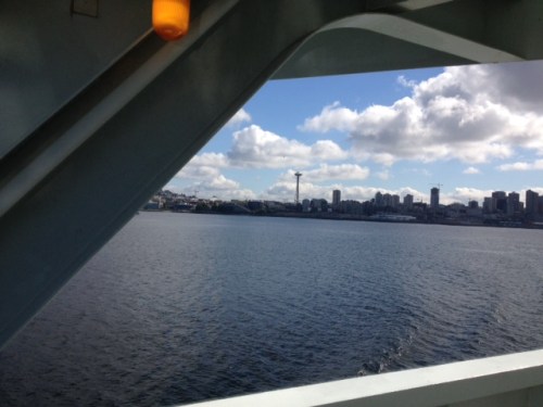 Through the window of the ferry, we sail away from Seattle.