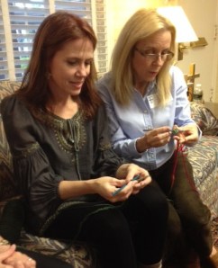 Brenda shows Jayne some crochet stitches. 