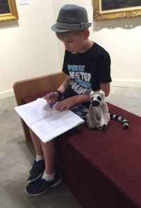 Hayden reads his story to Jack, the lemur.