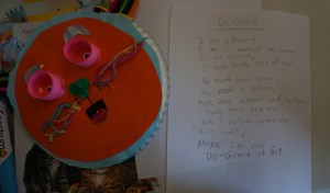 Dis-Grace I am a disgrace. I am a mess of an animal. I am rainbow. I have three sets of ears. My mouth stays open. My nose is green. People come around me and say "uhoo." They must hate me. Then I hear people say, "That's cool." Maybe I'm not a Dis-Grace after all. by Emily, 5th grade