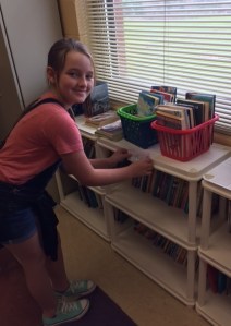 Kristina makes signs for the book shelves.